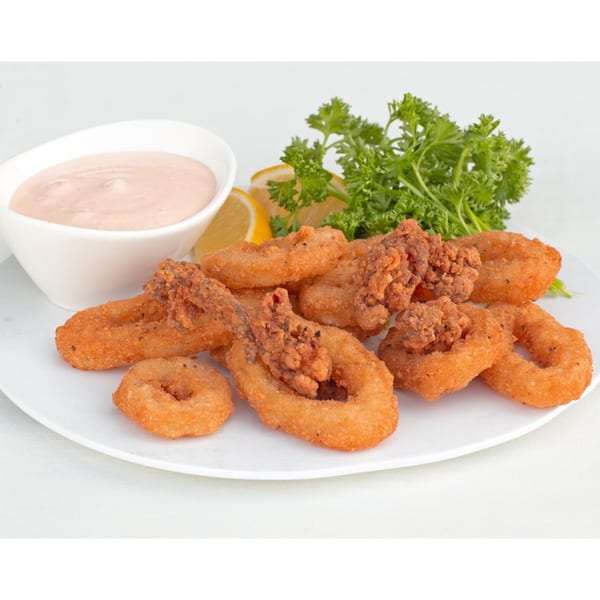 Fried calamari rings and tentacles with a side of pink sauce, lemon wedges, and parsley.